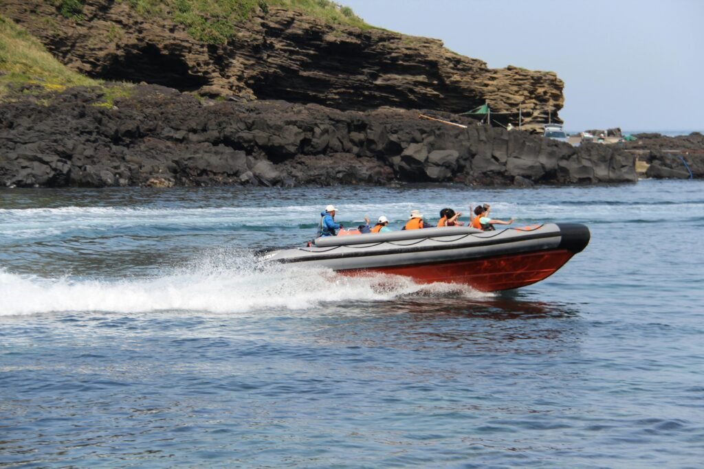 A thrilling motorboat ride with people enjoying the coastal view, perfect for adventure seekers.